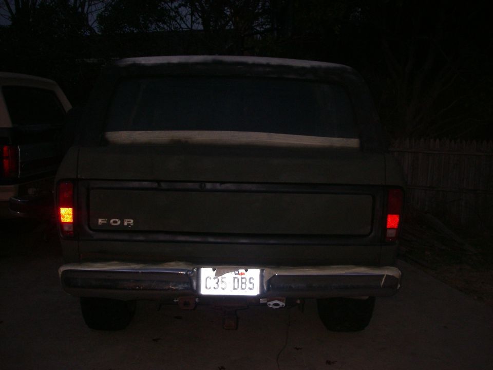 1978 Ford Bronco rear view, showing taillights, bumper, and license plate C35 DBS. Another vehicle is partially visible to the left