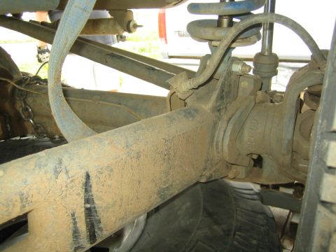 Dusty axle, coil spring and steering knuckle under an off-road vehicle