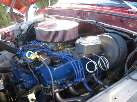 1979 Ford Bronco - Close-up view of a vehicle's engine compartment, showing the carburetor and brake booster.