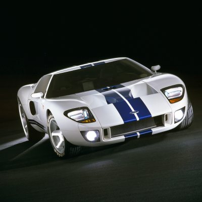 2003 Ford GT - A white Ford GT with blue racing stripes is shown from a front 3/4 angle against a dark background.