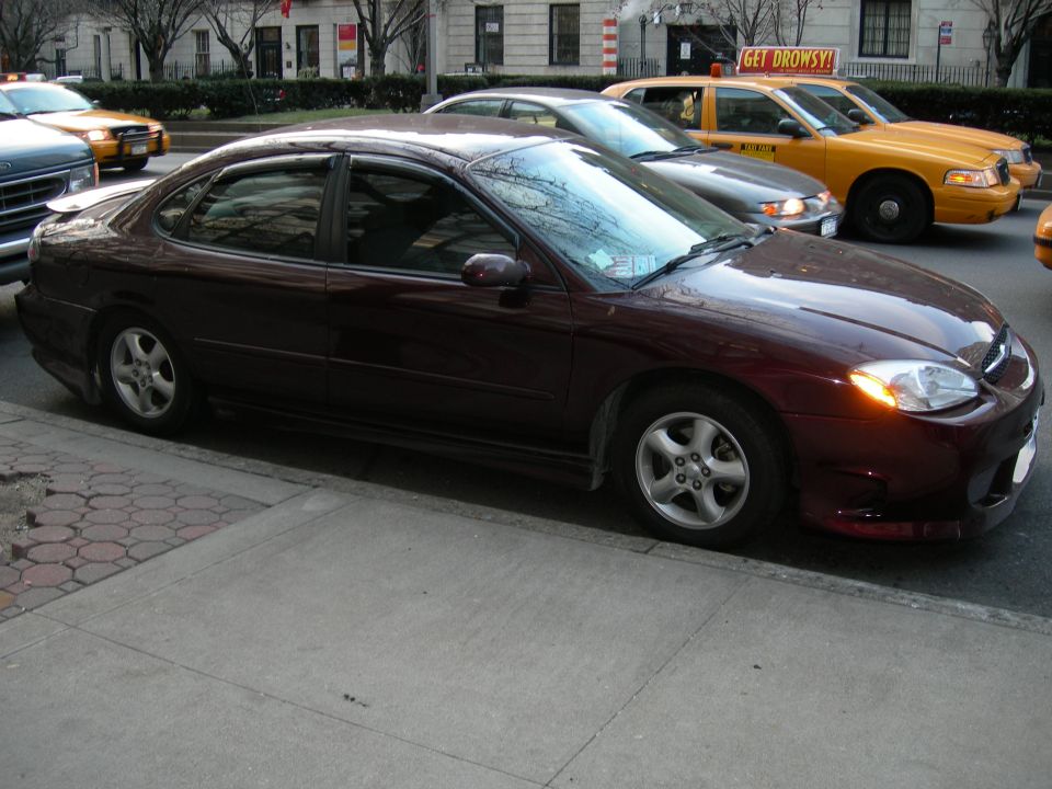 Maroon sedan, 3q-front view. Later model sedan