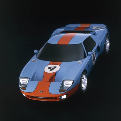 2003 Ford GT - A blue and orange Ford GT40 race car is shown from a three-quarter front angle against a dark background.