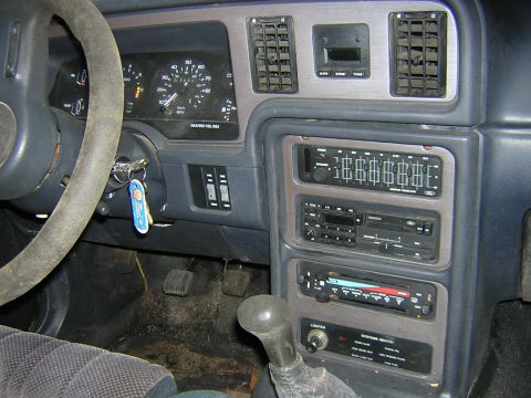 1987 Ford Thunderbird - The interior of a 1987 Ford Thunderbird shows wear and tear on the dashboard and steering wheel.