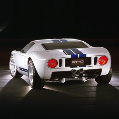 2003 Ford GT - Rear view of a white Ford GT sports car with blue racing stripes and a GT40 badge.