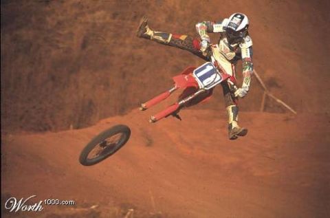 1968 Ford Mustang - A motocross rider is captured mid-air with their bike, as the front wheel has become detached during a jump.
