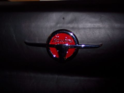 1972 Ford Ranchero - A close-up of a Ranchero emblem on a black surface.