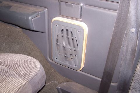 1990 Ford Bronco - Aftermarket speaker adapter installed in the interior door panel of a vehicle.