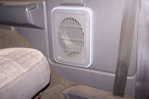 1990 Ford Bronco - Close-up of an aftermarket speaker adapter installed in a vehicle's interior panel.