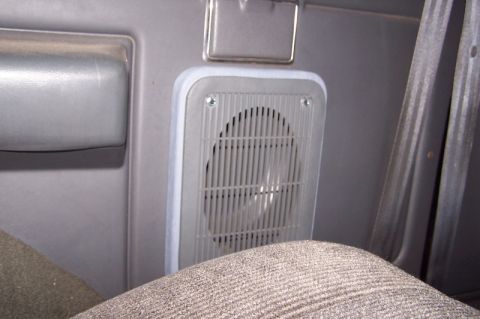 1990 Ford Bronco - Close-up of a speaker grille inside a vehicle, with a portion of a seat visible.