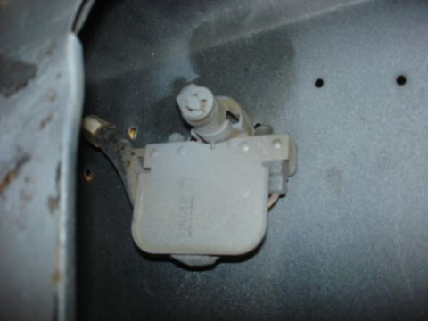 1979 Ford Bronco - A close-up view of a vehicle's electrical component, possibly an ignition coil, with visible text markings.