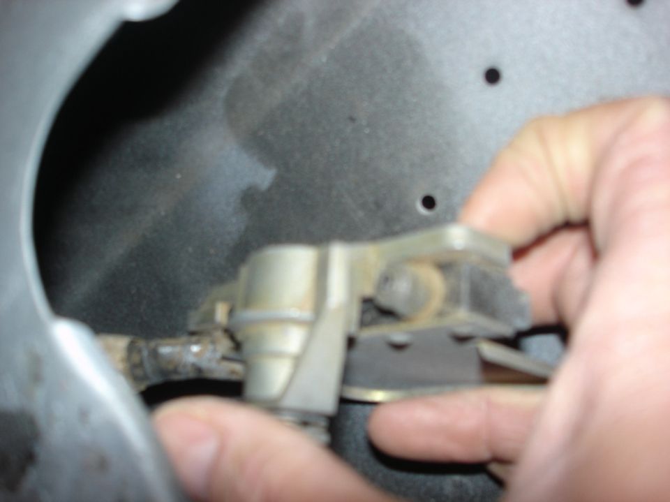 Hand holding metal latch mechanism