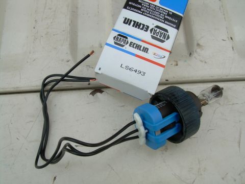 1997 Ford F-150 - Headlight bulb and socket assembly with NAPA Echlin packaging.