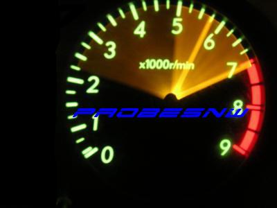 1988 Mazda MX-6 - Close-up of a car's tachometer gauge, showing engine RPM and some blue text.