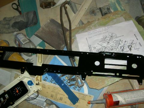 1967 Ford Ranchero - A black dashboard trim piece is shown with a wiring diagram and various tools and supplies.
