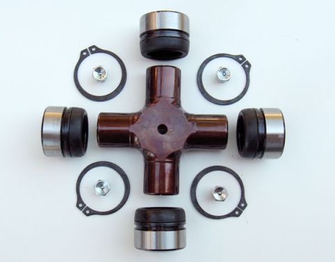 1991 Ford Bronco - A universal joint kit, including the cross piece and bearing caps, laid out for assembly.