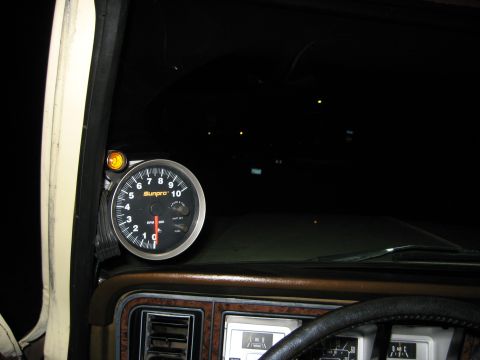 1979 Ford Bronco - A Sunpro tachometer gauge is visible inside a vehicle's cabin.