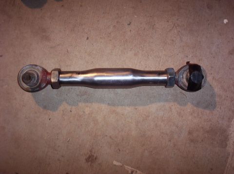 1987 Jeep Cherokee - Adjustable suspension linkage with rod ends, one end covered with black tape.