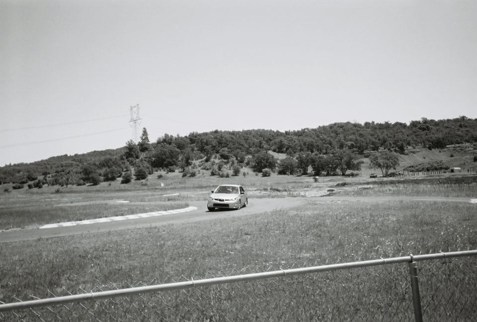 Silver sedan on a race track, front view
