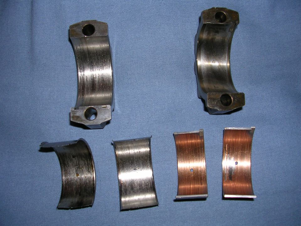 worn engine bearings, some with copper showing through