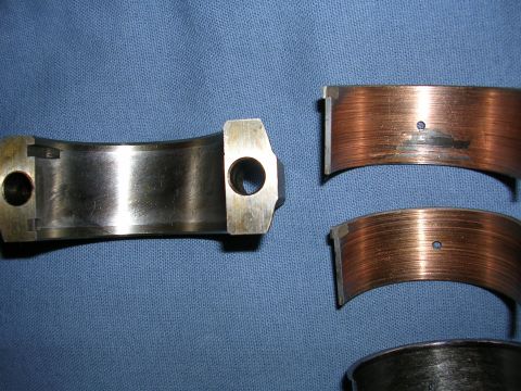 1996 Ford Probe - Worn engine bearings showing signs of significant damage and scoring.