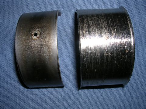 1996 Ford Probe - These engine bearings show significant wear and damage, indicating a potential mechanical issue.