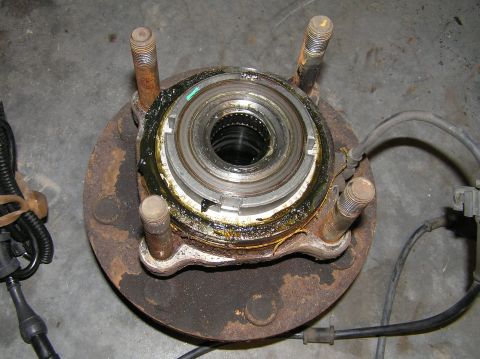 2000 Ford Excursion - The old hub assembly. Notice the 4 studs (threaded on each end). The studs feed through the holes in the steering knuckle and have 4 bolts…