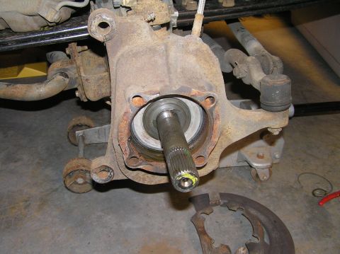 2000 Ford Excursion - Close-up of the front passenger knuckle with wheel, caliper, hub assembly, and brake dust shield removed.