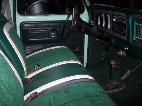 1994 Ford F-150 - Interior view of a vintage truck, a green and white striped bench seat and dashboard details.
