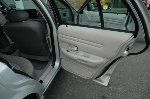 2003 Ford Crown Victoria - Interior view of a 2003 Ford Crown Victoria with both front and rear doors open.