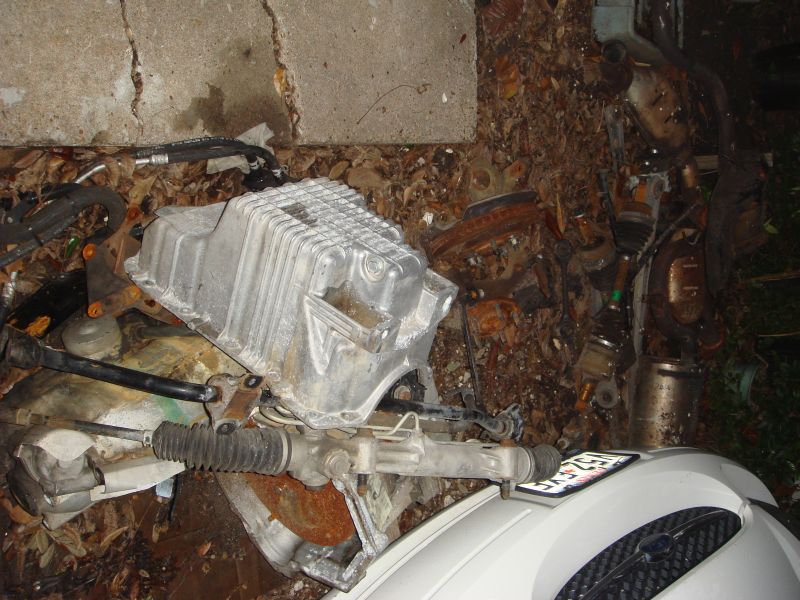 Engine oil pan and steering rack assembly on the ground