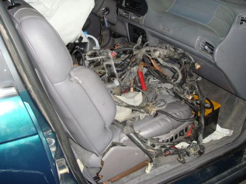 1993 Ford Taurus - Interior view of a 1993 Ford Taurus with a complex wiring harness occupying the passenger seat area.