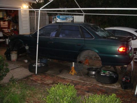1993 Ford Taurus - This 1993 Ford Taurus is elevated on jack stands, with its wheels off for maintenance.