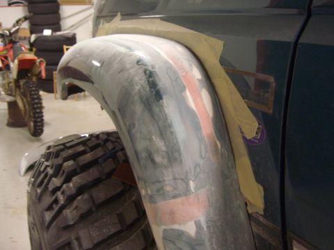 1996 Ford Bronco - Fender repair in progress, showing body filler and masking tape application.