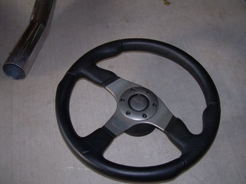 1996 Ford Probe - A Momo steering wheel and a section of exhaust pipe are shown, neither of which are identifiable as a 1996 Ford Probe.