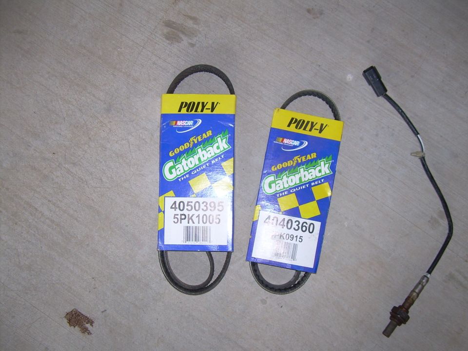Two Goodyear Gatorback Poly-V belts with part numbers 4050395 5PK1005 and 4040360 6PK0915, plus an oxygen sensor