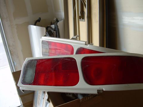 1996 Ford Probe - A pair of car tail lights are stored in a garage, possibly for a project or repair.