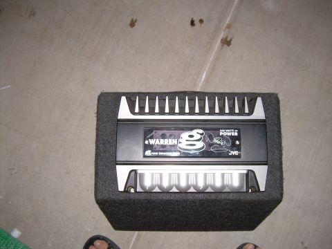 1996 Ford Probe - A car amplifier with branding and power rating is shown inside a speaker enclosure.