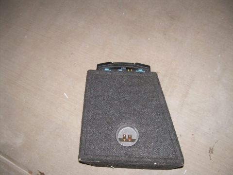 1996 Ford Probe - A car amplifier is mounted on top of a speaker enclosure.