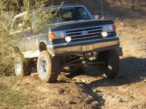 1991 Ford Bronco - This 1991 Ford Bronco navigates a dusty, off-road trail, its capabilities.