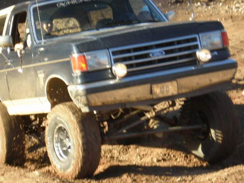 1991 Ford Bronco - This 1991 Ford Bronco is shown with its grille and headlights, lifted suspension, and off-road tires.