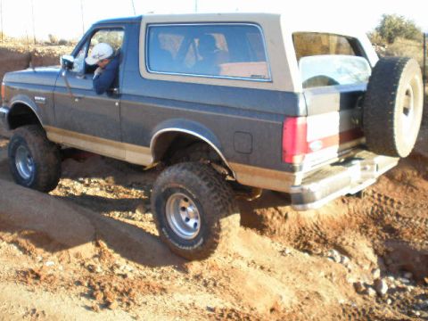 1991 Ford Bronco - This 1991 Ford Bronco is navigating a challenging dirt path.