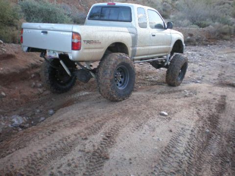 1991 Ford Bronco - This modified Toyota Tacoma pickup truck is equipped for off-road driving on a dirt path.