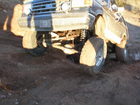 1991 Ford Bronco - This lifted 1991 Ford Bronco navigates a rough dirt trail, its off-road capabilities.