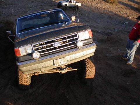 1991 Ford Bronco - This 1991 Ford Bronco navigates a dirt trail, its iconic grille and front-end design.