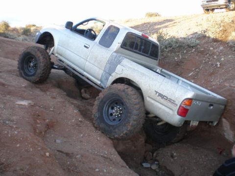 1991 Ford Bronco - This modified Toyota Tacoma TRD navigates a challenging rocky terrain.