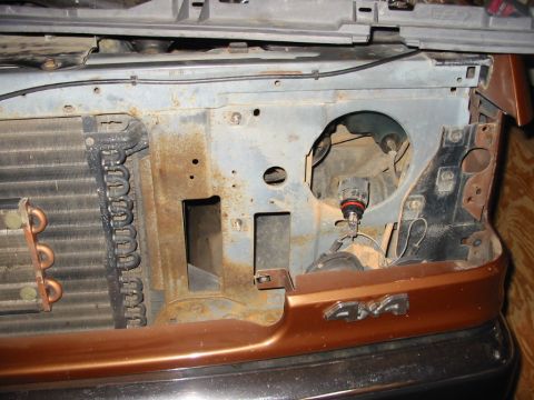 1988 Ford Bronco - Front end of a 1988 Ford Bronco with the grille and headlight assembly removed, revealing the radiator.