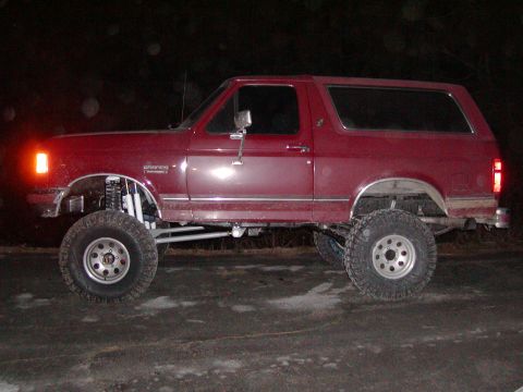 1991 Ford Bronco - This lifted 1991 Ford Bronco is shown from the side, large off-road tires.