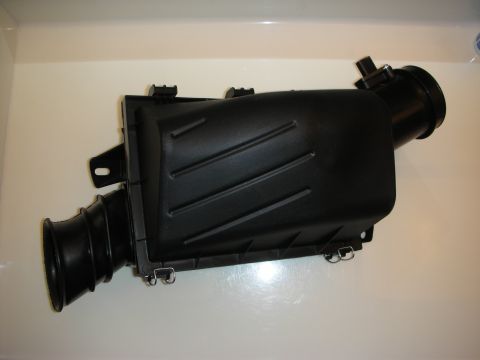 1998 Ford Crown Victoria - black molded plastic air intake/airbox assembly with inlet snorkel photographed on a white background.