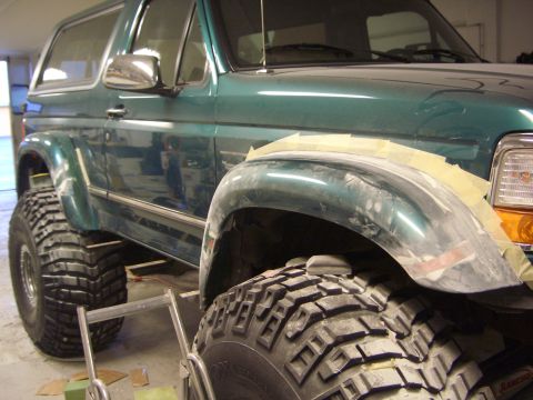 1996 Ford Bronco - 1996 Ford Bronco undergoing modifications with custom fender flares and large tires.