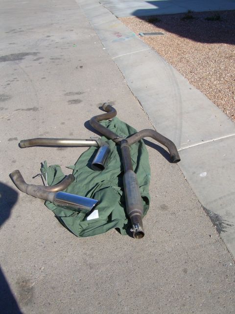 1996 Ford Probe - Several exhaust pipes and mufflers are visible on the ground.